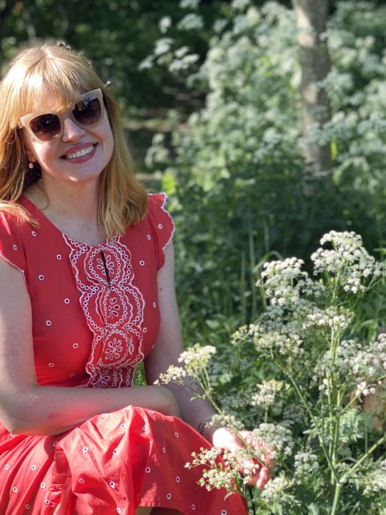 woman sitting among cow parsley