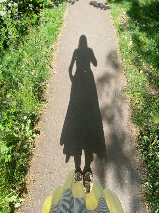 shadow of woman walking in a park